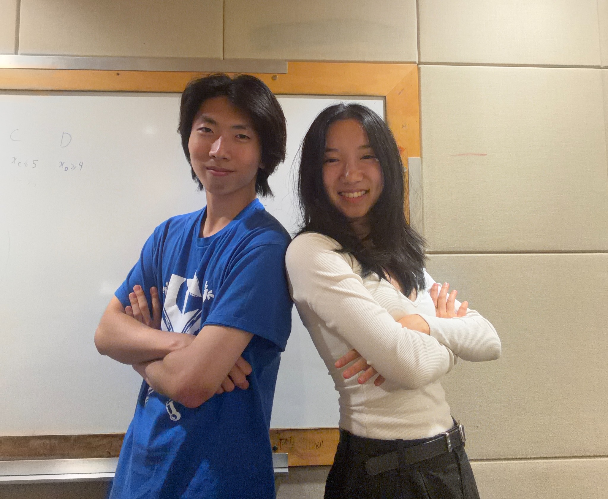 Co-founders Joon and Isabella standing back to back